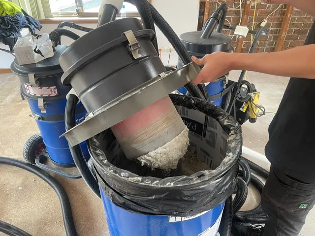 Dirt Eater HEPA industrial vacuum in action on a Houston jobsite