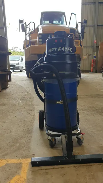 Dirt Eater Jr compact HEPA industrial vacuum in action on a jobsite