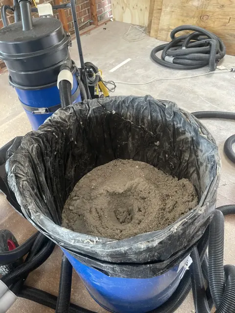 HireAVac HEPA industrial vacuum equipment collecting hazardous dust